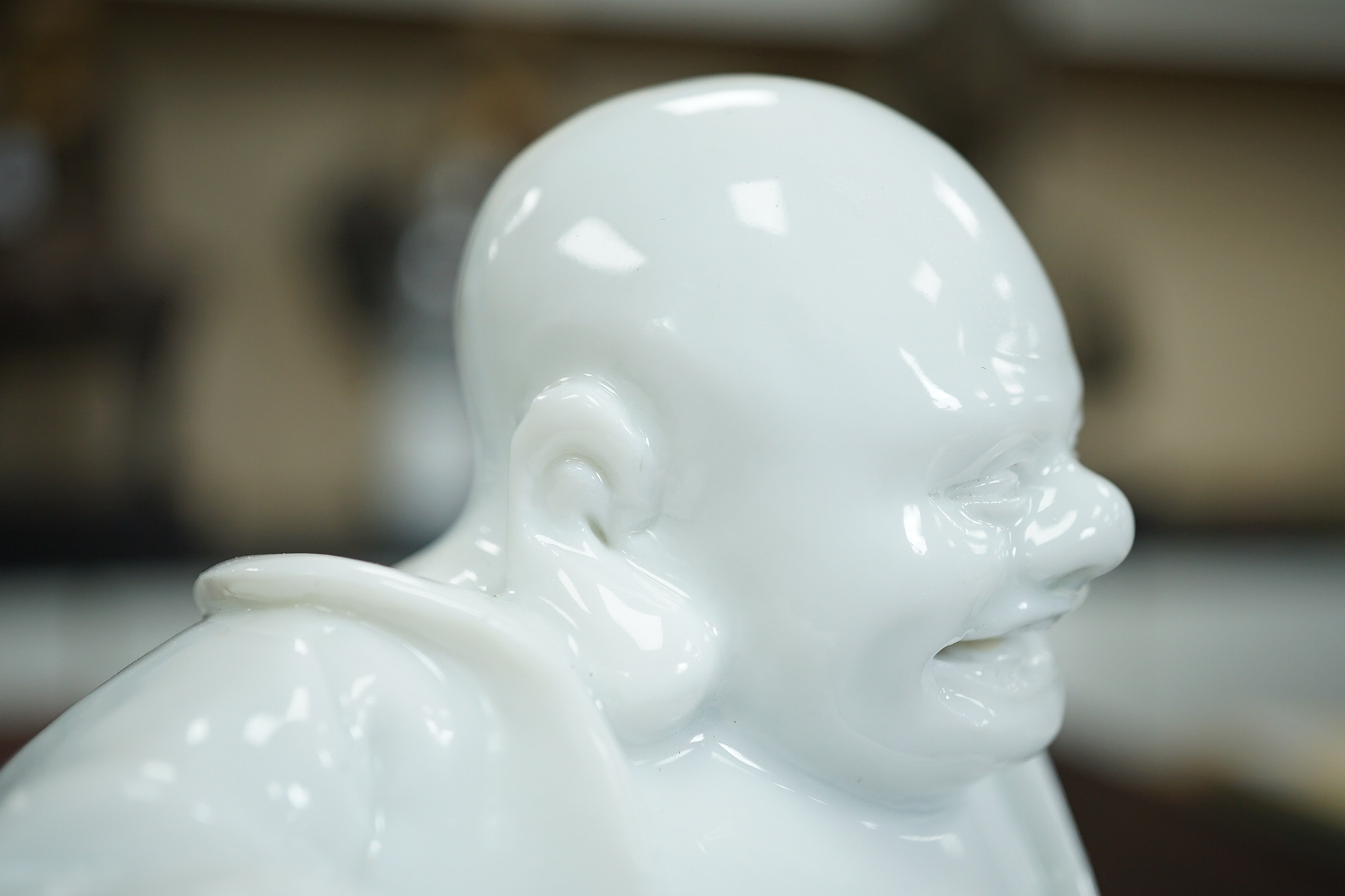 A Chinese blanc-de-chine seated figure of Budai, 18th/19th century